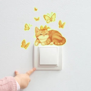 Luminous cartoon sleeping cat and butterflies wall sticker on a white light switch