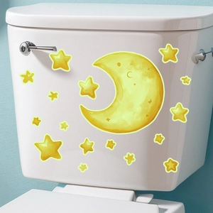 Luminous watercolor moon and stars self-adhesive decals applied on a white toilet tank