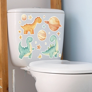 Glow-in-the-dark dinosaur stickers featuring moons and stars on a white toilet tank