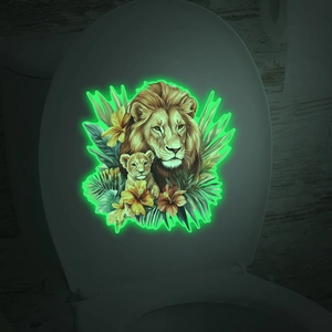 Luminous toilet lid sticker showing glowing lion family with tropical flowers in the dark