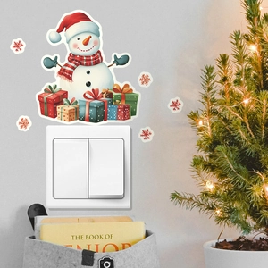 Detailed view of luminous Christmas snowman and gift box wall stickers near light switch