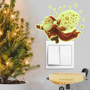 Luminous Santa Claus and stars wall sticker glowing on a light switch panel