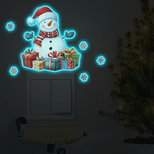 Luminous snowman and snowflake wall switch stickers glowing blue in dark room