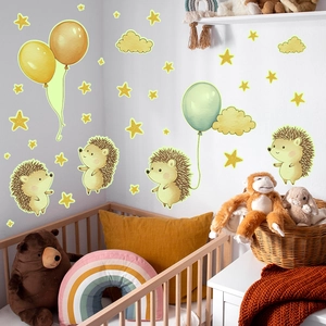 Detail of hedgehog and balloon wall stickers glowing in a cozy nursery setting