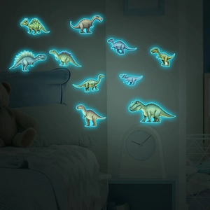 Luminous cartoon dinosaur wall stickers glowing in a dark kids bedroom at night