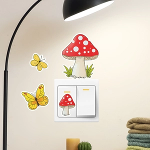 Close-up of luminous cartoon mushroom and yellow butterfly wall stickers for light switches