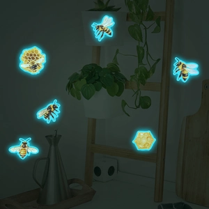 Luminous wall stickers featuring realistic glowing bees and honeycomb patterns for home decor