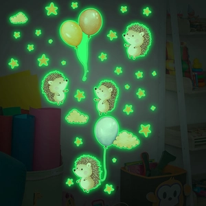 Detailed view of luminous hedgehog and balloon wall stickers glowing bright green in the dark