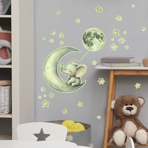 Luminous wall stickers featuring elephant on moon with glowing stars for a kids bedroom