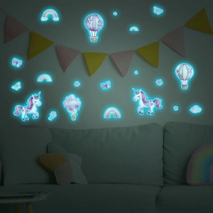Luminous wall stickers showing glowing cartoon unicorn and hot air balloon in dark bedroom