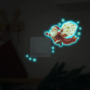 Luminous Christmas Santa and stars wall switch sticker with glowing blue night effect