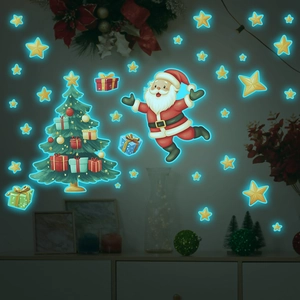 Luminous wall stickers showing glowing blue Santa and Christmas tree stars in the dark
