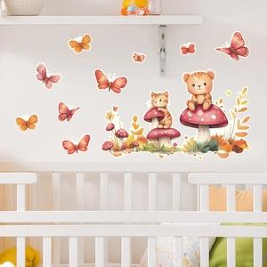 Nursery wall decals featuring watercolor animals and mushrooms above a white baby crib