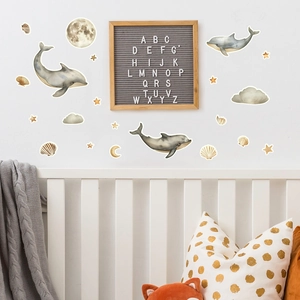 Nursery room wall stickers set with watercolor dolphins, moon, and stars in earthy tones