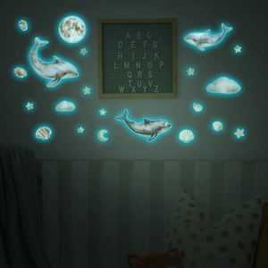 Luminous wall stickers set with blue glowing dolphins, moon, stars and clouds for bedroom
