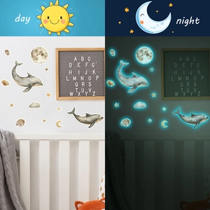 Luminous ocean themed wall stickers featuring whales and stars in day and night contrast