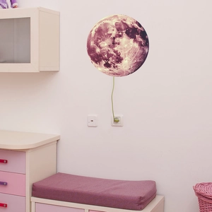 Detailed realistic moon wall light with crater textures and green power cord in a kids room