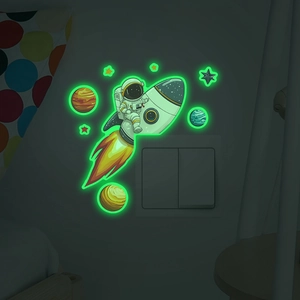 Luminous astronaut riding rocket wall decal with glowing planets for kids' room switch decor