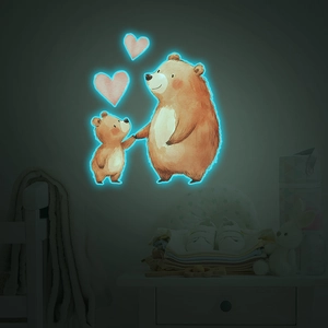 Luminous wall sticker showing cartoon bears glowing in a dark nursery bedroom setting