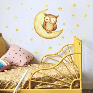 Luminous wall decal showing a cute owl on a yellow moon with many glowing stars