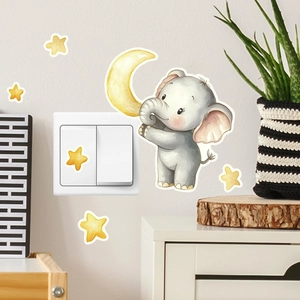 Detail of cartoon elephant and stars wall sticker next to a white light switch
