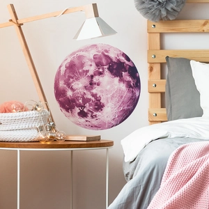 Detailed close-up of a glowing purple moon wall sticker with crater texture in a cozy bedroom