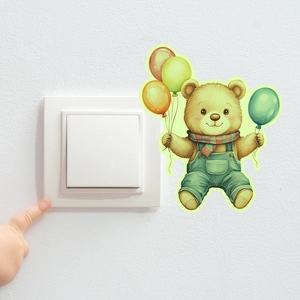 Glow-in-the-dark teddy bear wall sticker holding balloons next to a light switch