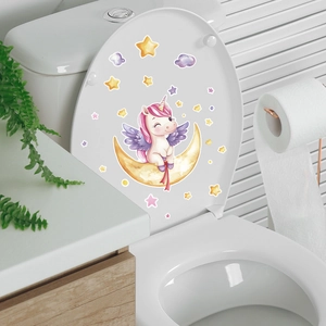 Luminous unicorn and stars stickers on a white toilet lid in a home bathroom setting