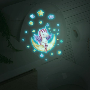 Luminous unicorn and star decals glowing in the dark on a bathroom toilet lid
