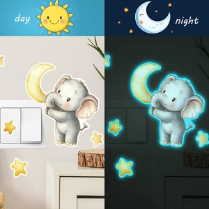 Glow-in-the-dark elephant and stars wall sticker shown in day and night comparison