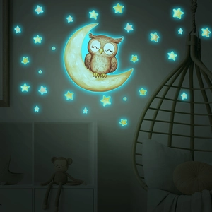 Glow-in-the-dark wall stickers featuring a sleeping owl on a moon with scattered stars