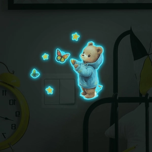Glow-in-the-dark wall stickers featuring a cute brown bear, stars, and butterflies near a switch