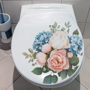 Floral toilet seat decal featuring pink roses and blue hydrangeas on white ceramic