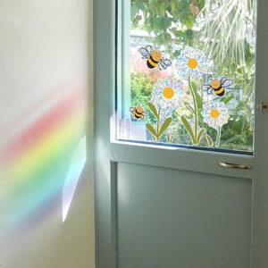 Rainbow suncatcher window stickers with bees and daisies projecting light effects