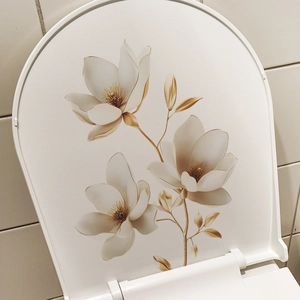 Detailed close-up of magnolia floral pattern with gold outline on a white toilet lid decal