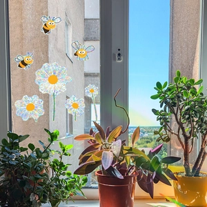 Rainbow window decals with bees and sunflowers on glass creating colorful light effects