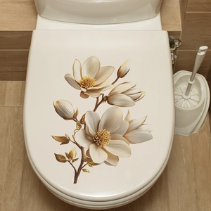Close-up of elegant gold and white magnolia floral decals on a bathroom toilet lid