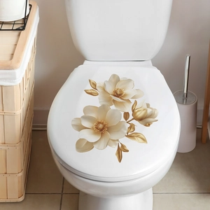 Detail of self-adhesive gold magnolia flower wall decals on a modern toilet lid