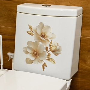 Detailed view of elegant gold magnolia floral decals applied to a white ceramic toilet tank