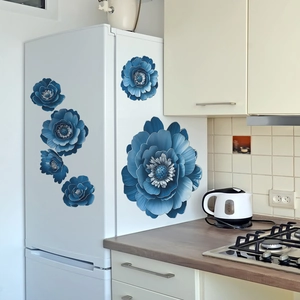 Blue 3D floral wall stickers with gold edges applied to a white refrigerator surface