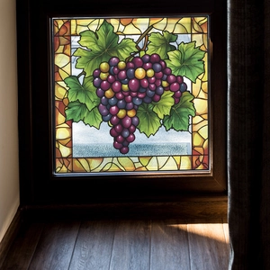 Artistic stained glass window film with purple grape cluster design on dark wood frame
