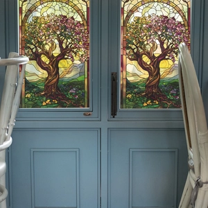 Artistic stained glass tree window film with colorful floral landscape pattern on blue door