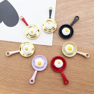 Macro detail of various colorful fried egg pan charms for creative DIY jewelry making