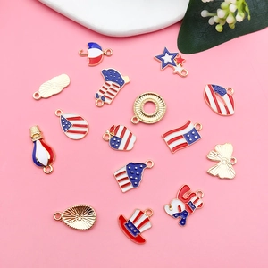 Flat lay of diverse USA patriotic charms in red white and blue enamel with gold finish
