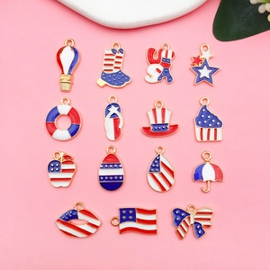 Flat lay of 15 Independence Day alloy charms with USA flag theme and red blue enamel finish