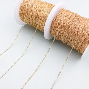 Macro shot of 18K gold-plated O-chain wound on a spool for DIY jewelry making