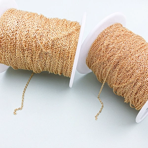 Macro detail of 18K gold-plated copper cable chain wound on white plastic spools for DIY