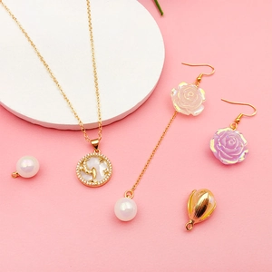 Detail of 18K gold-plated jewelry set featuring moon cat pendant and rose flower earrings