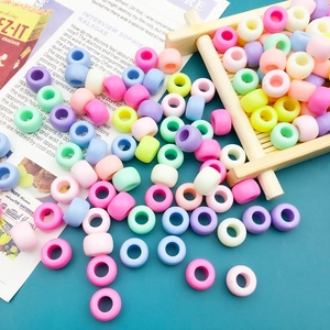 Assorted candy-colored 6x9mm acrylic beads with large holes for DIY crafts on a wooden tray