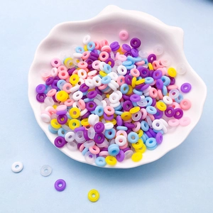 Mix of colorful 6mm silicone O-ring spacer beads for DIY jewelry making in a shell bowl